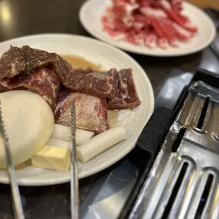 a plate of meat and onions