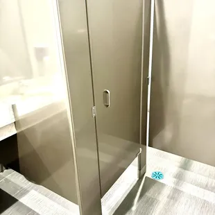 a bathroom with a glass shower stall