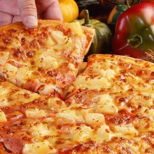 a person taking a slice of pizza