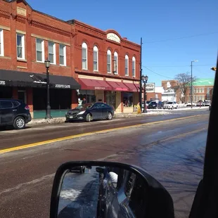 On the corner next to the barber shop.