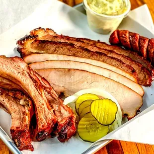 a platter of meats and sides