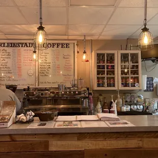 a counter with a menu on the wall