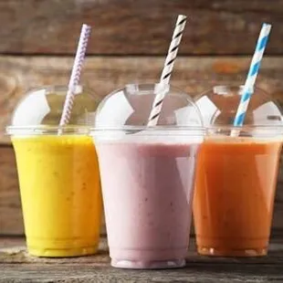 three smoothie drinks with straws