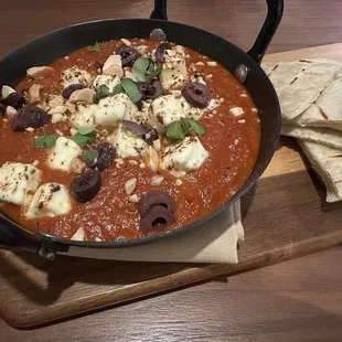 BAKED FETA WITH KALAMATA OLIVES shakshuka, sumac tossed marcona almonds