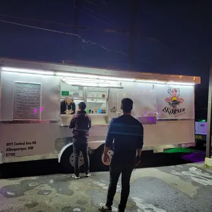 a man standing in front of a food truck