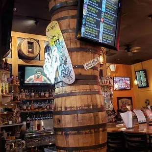 a wooden barrel with a sign on it