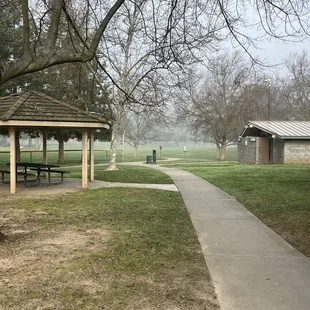 Small covered table area by playground close to bathrooms
