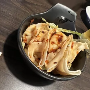 Spicy dumplings -- they were good &amp; we loved the cabbage at the bottom, but they definitely needed to be more temperature hot