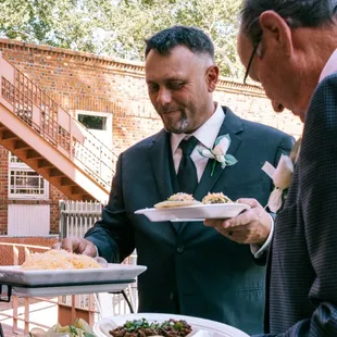 The groom picks from all of the toppings that come with the bar.