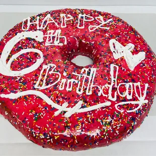 a birthday donut with sprinkles