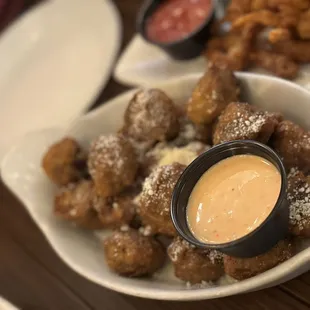 a plate of food with dipping sauce