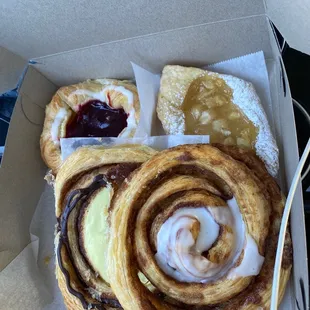 Cinnamon roll, cinnamon roll with custard, raspberry danish and apple diamond.