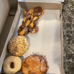 Assortment, maple glazed, apple fritter, Bismarck, tiger tail