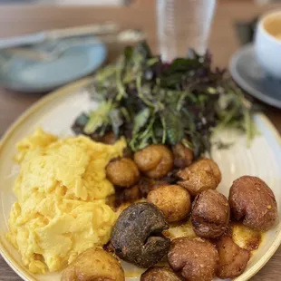 Two eggs any style with a side salad and smashed crispy potatoes