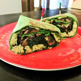 Vegetarian Brunch: Scrambled eggs, sauteed spinach and much rooms, crushed avocado, a hint of chili on a spinach wrap. Served Toasted.