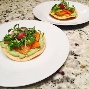 Salmon sashimi tostada with guac, serranos, and pickled red pearls