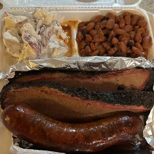 Brisket plate with potato salad, baked beans, and a regular smoked sausage.