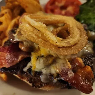 a burger with onion rings