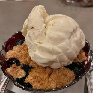 a blueberry pie with ice cream