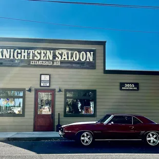 a classic car parked in front of a building