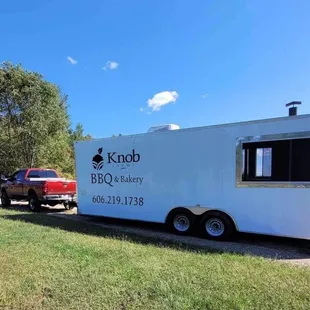 a truck parked in front of a trailer