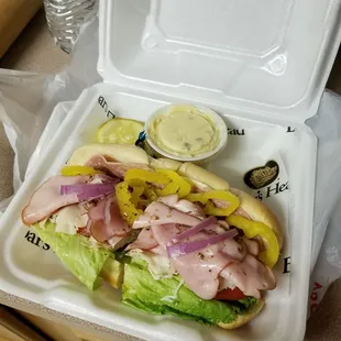 a sandwich in a styrofoam container