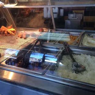 fried chicken and rice in a display case