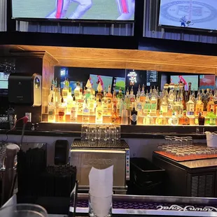 multiple televisions and liquor bottles