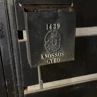 a black mailbox with the name knosss gyros on it