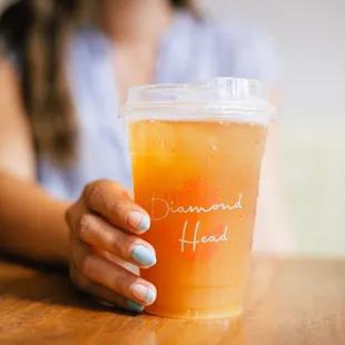 a woman holding a drink