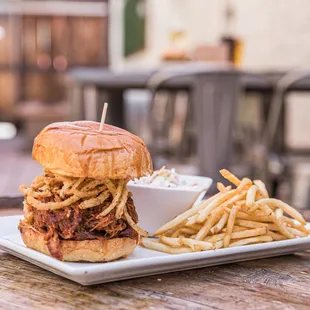 a plate of fries and a pulled pork sandwich