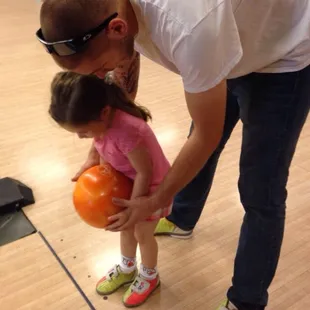 My granddaughter learning how to bowl...