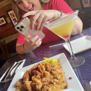 a woman taking a picture of her food