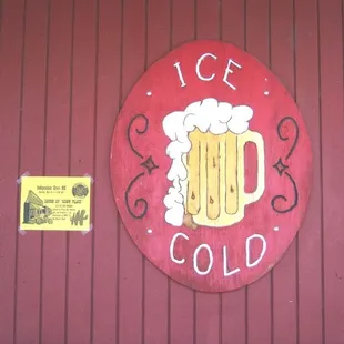 a red sign with a mug of beer on it
