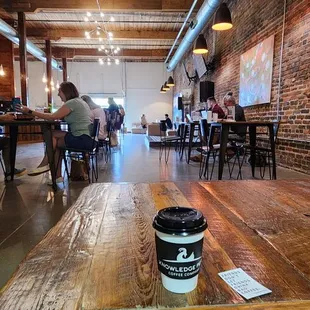 a coffee cup on a table in a coffee shop