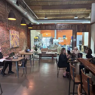 Seating area in the back with couches and 2 person tables.