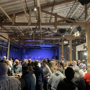 Lower level indoors with a band on stage