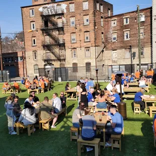 a large group of people sitting at picnic tables