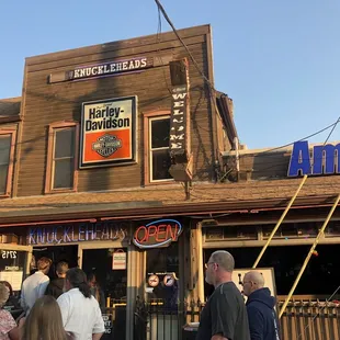Front entrance to the building in the right with outdoor seating.