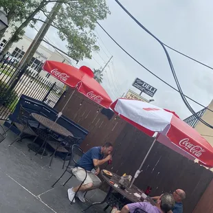 two men eating outside