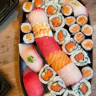Take-out sushi, Rainbow Roll, spicy tuna box, Salmon Roll, yellowtail and tuna sushi
