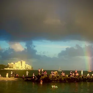 Folks on the wall watching the sunset.