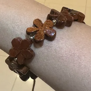 Love this string bracelet with plumeria in koa wood!