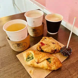 Tea, cherry latte, flat-white coffee, croissant, scone, and cake pop