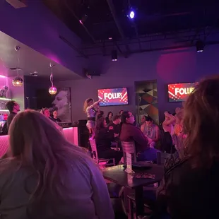 a group of people sitting at a bar