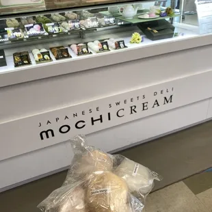 a person holding a bag of doughnuts