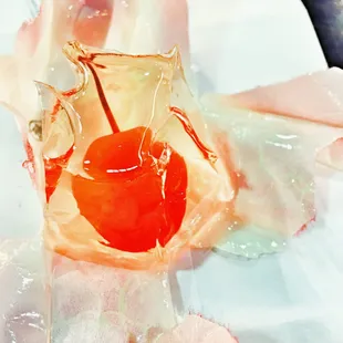 a close up of a piece of ice with a cherry in it