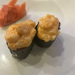 two sushi rolls on a plate