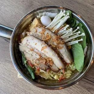 a bowl of ramen and vegetables