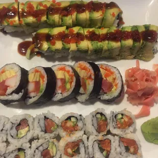 a plate of sushi and rolls